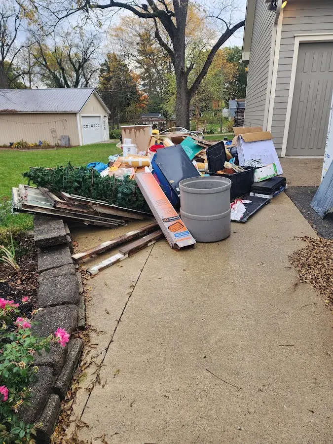 Dumpster being loaded with debris for 12 Yard Dumpster Rental in Laurel
